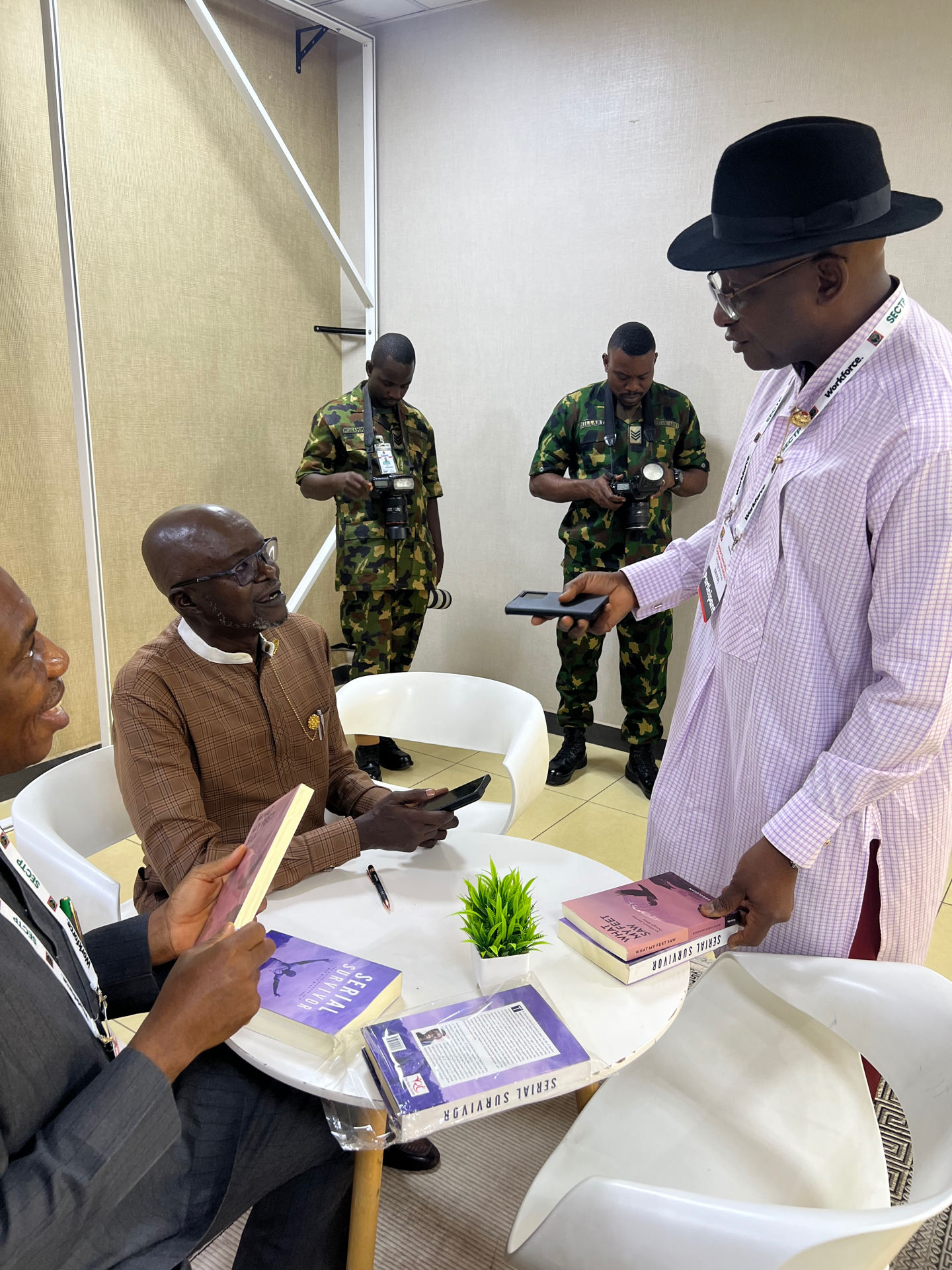 Signing copies of his books